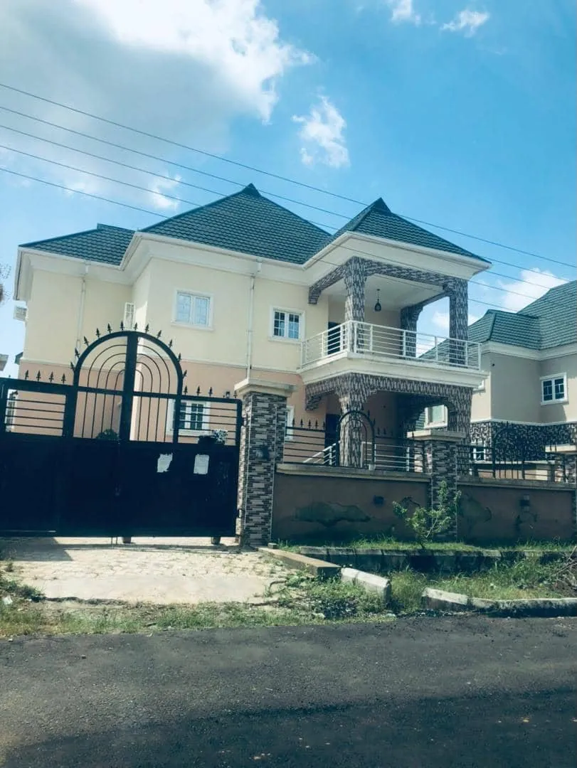 Completed detached duplex behind a wrought-iron gate
